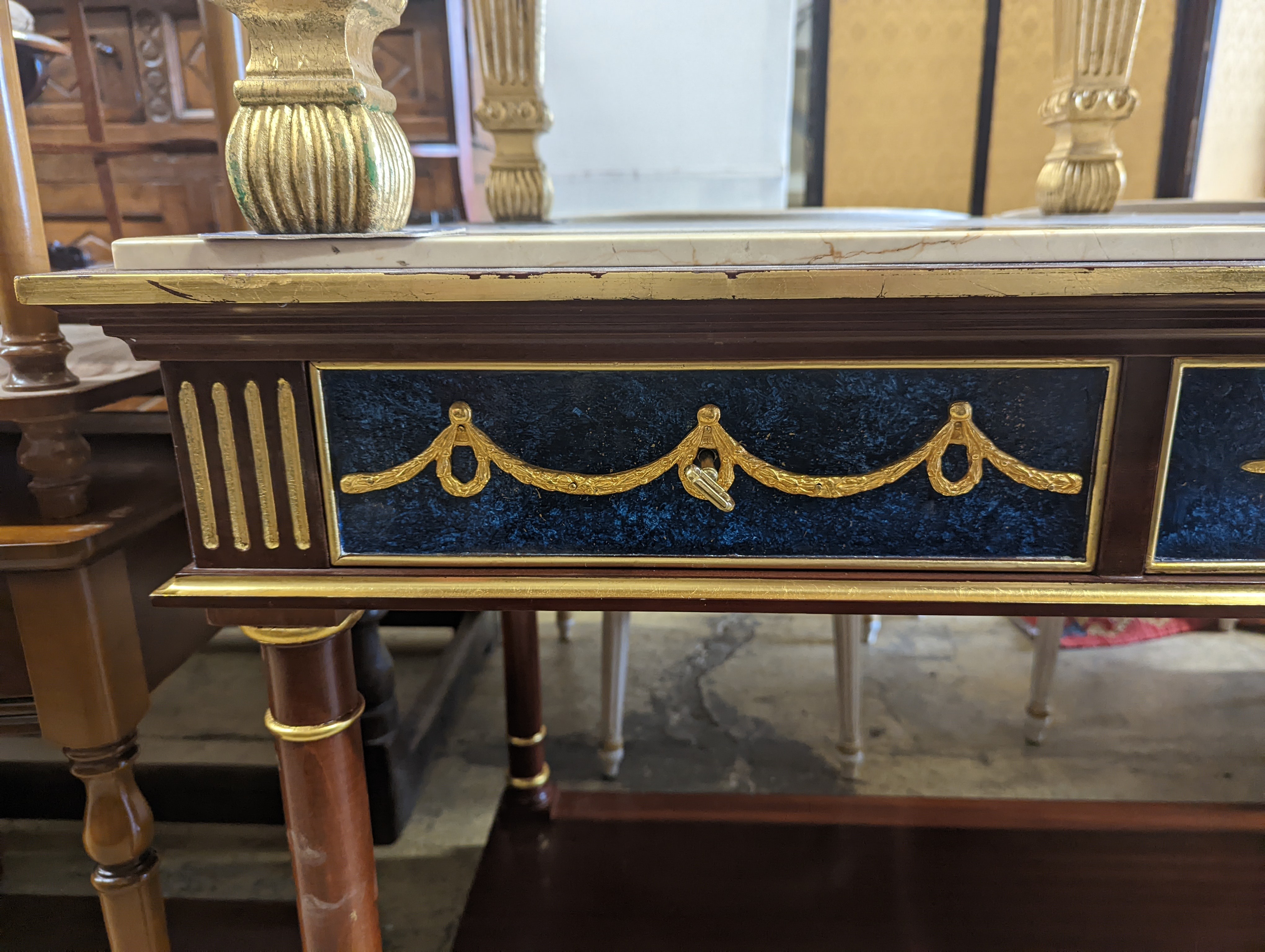 An Empire style parcel gilt and faux malachite marble top console table with concave undertier, width 154cm, depth 65cm, height 80cm